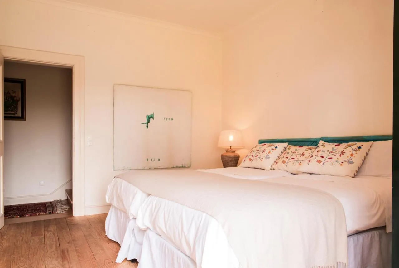 Bedroom with two single beds and white linen